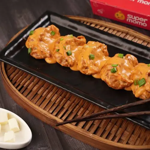 Paneer Tikka Pan Fried Momo in Butter Masala